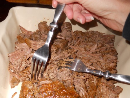 Shredding the Beef after long slow cooking.